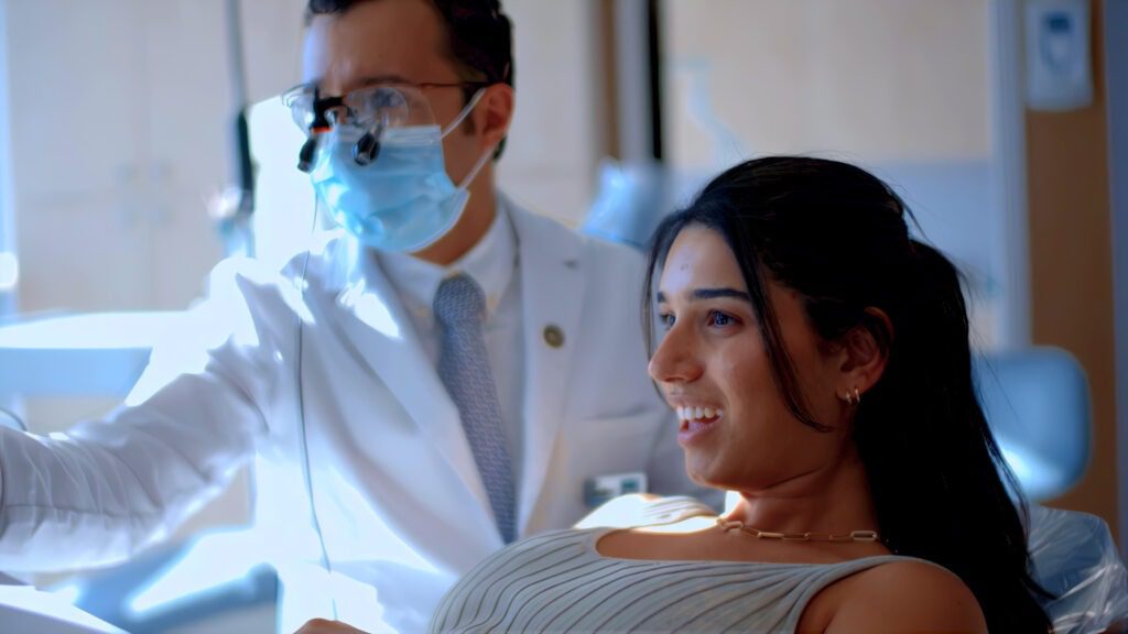 Dr. Dadjoo smiling with a young patient after a free orthodontic consultation in Porter Ranch